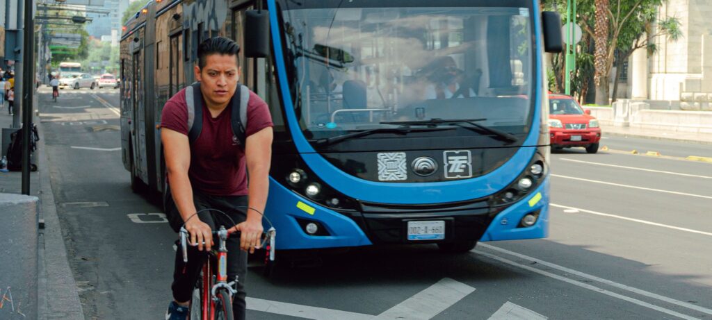 bus and cyclist in multimodal non-vehicle lane