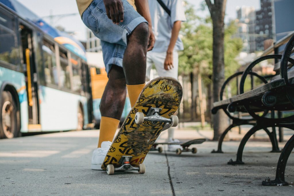 bus riders at bus stop with skateboards