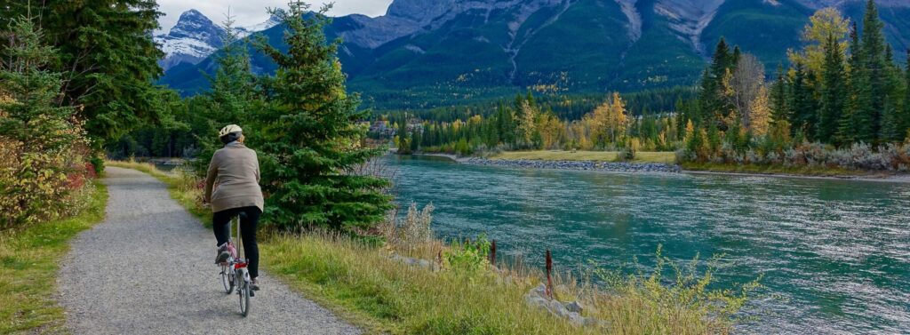 bicyclist on trail through lush natural scenery